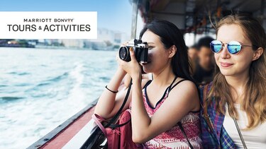    Marriott Bonvoy Tours and Activities. 2 women taking pictures from a boat  