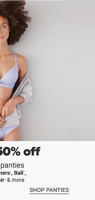 A woman in a light purple bra and panty set. Doorbuster, up to 50% off bras and panties from Bali, Vanity Fair, Playtex and more, shop bras, shop panties.